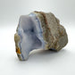 Top-down shot of Blue Lace Agate raw geode, showing natural banding, traditionally used for Stress Relief.