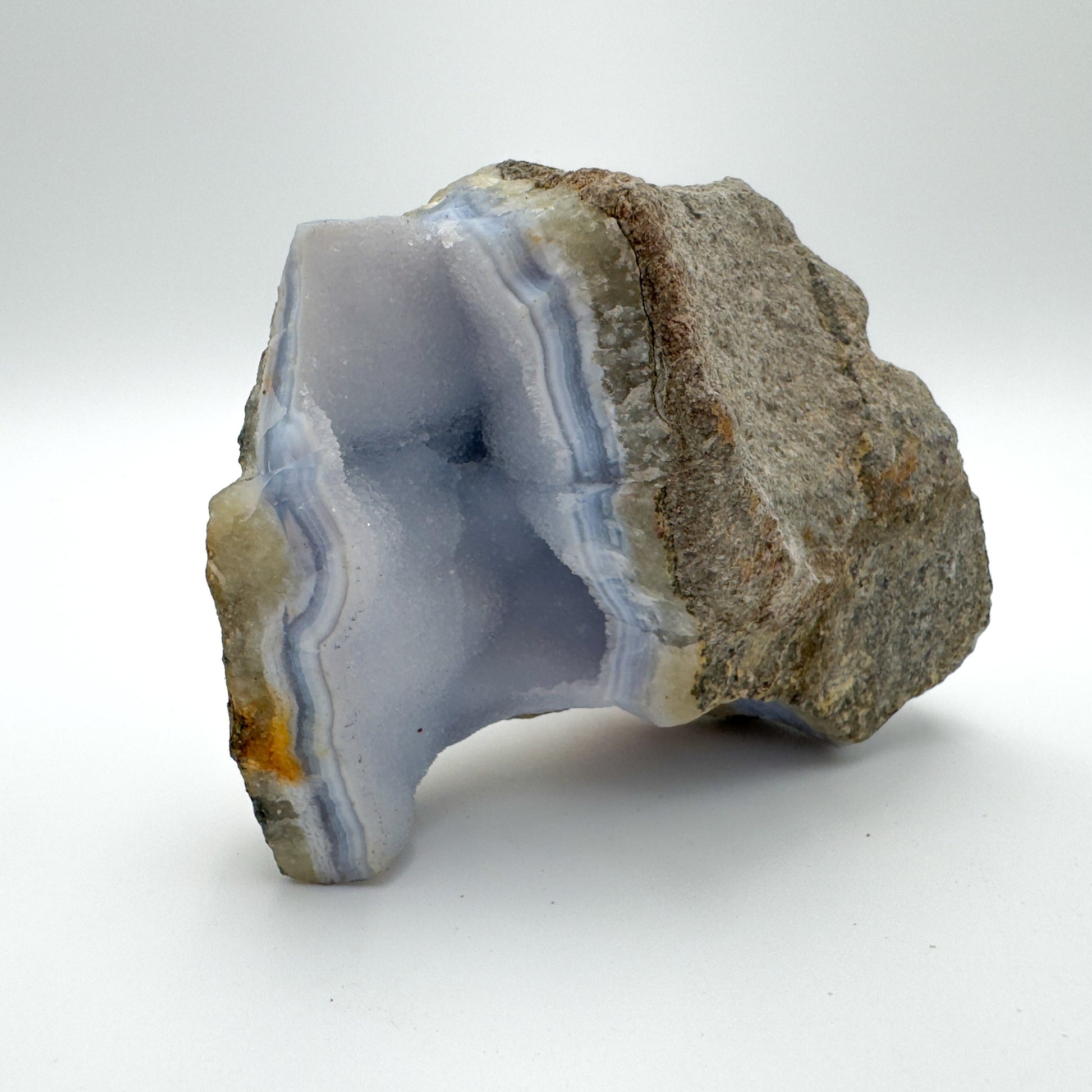 Top-down shot of Blue Lace Agate raw geode, showing natural banding, traditionally used for Stress Relief.