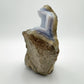 Hand-held view of a single Blue Lace Agate raw geode sourced from Malawi.