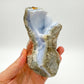 Grade aa blue lace agate geode held in hand for size reference