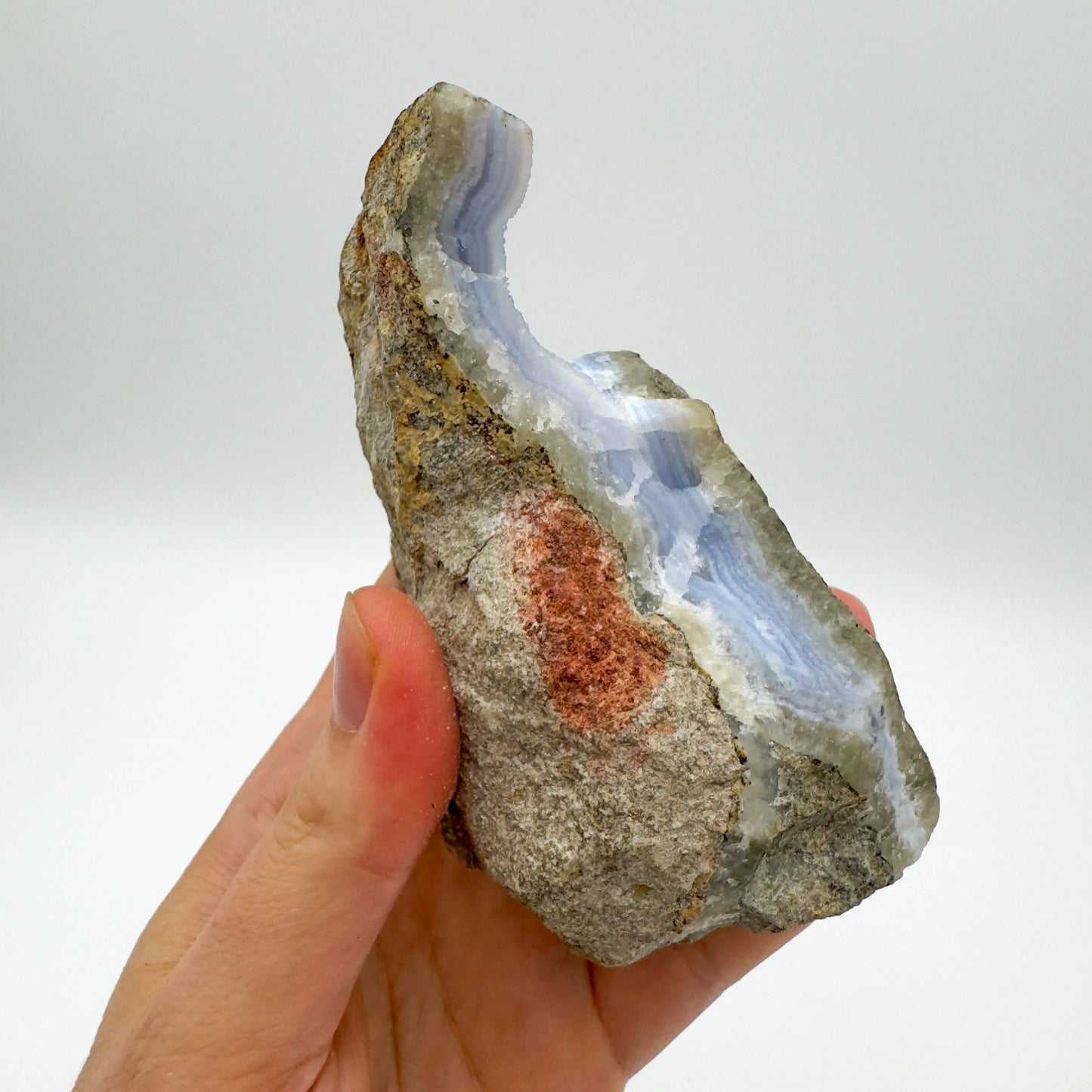 Detail shot of Grade AA Blue Lace Agate geode under natural light