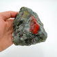 Worktop view of Bloodstone specimen, from Hhohho, Eswatini, traditionally used for Protection, with weight visible in the palm.