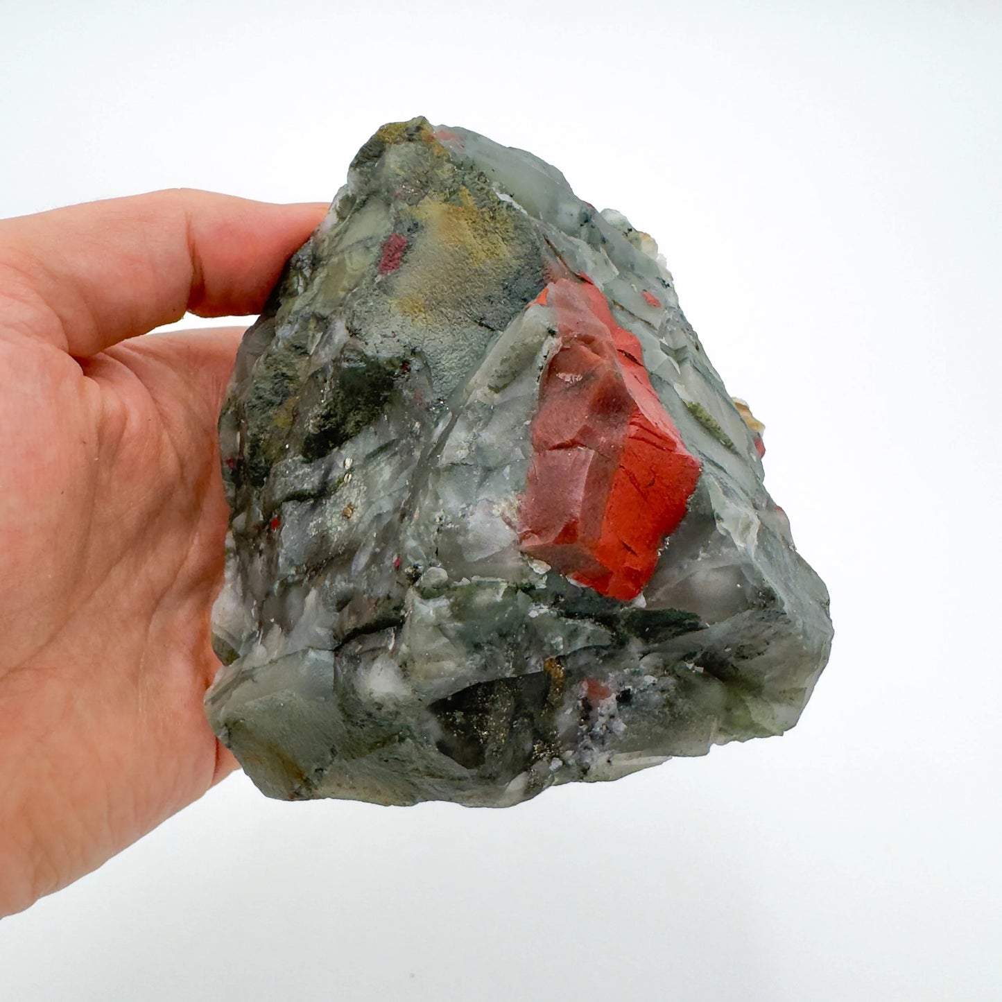 Worktop view of Bloodstone specimen, from Hhohho, Eswatini, traditionally used for Protection, with weight visible in the palm.