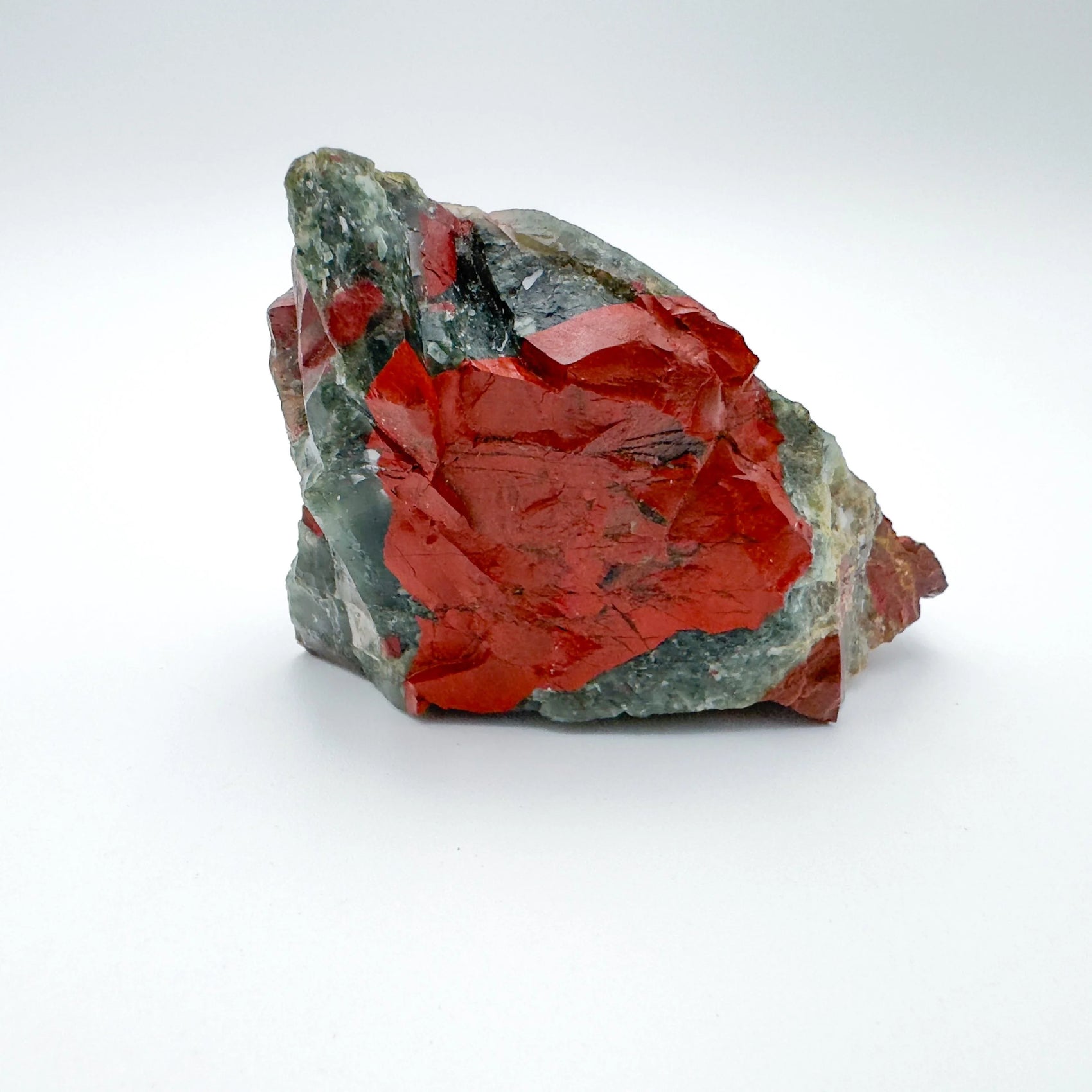 Side perspective of Grade AA Bloodstone specimen, often kept for Energy, showing characteristic finish.