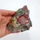 Companion image of Bloodstone specimen, from Hhohho, Eswatini, linked to Grounding, with subtle natural color showing through.