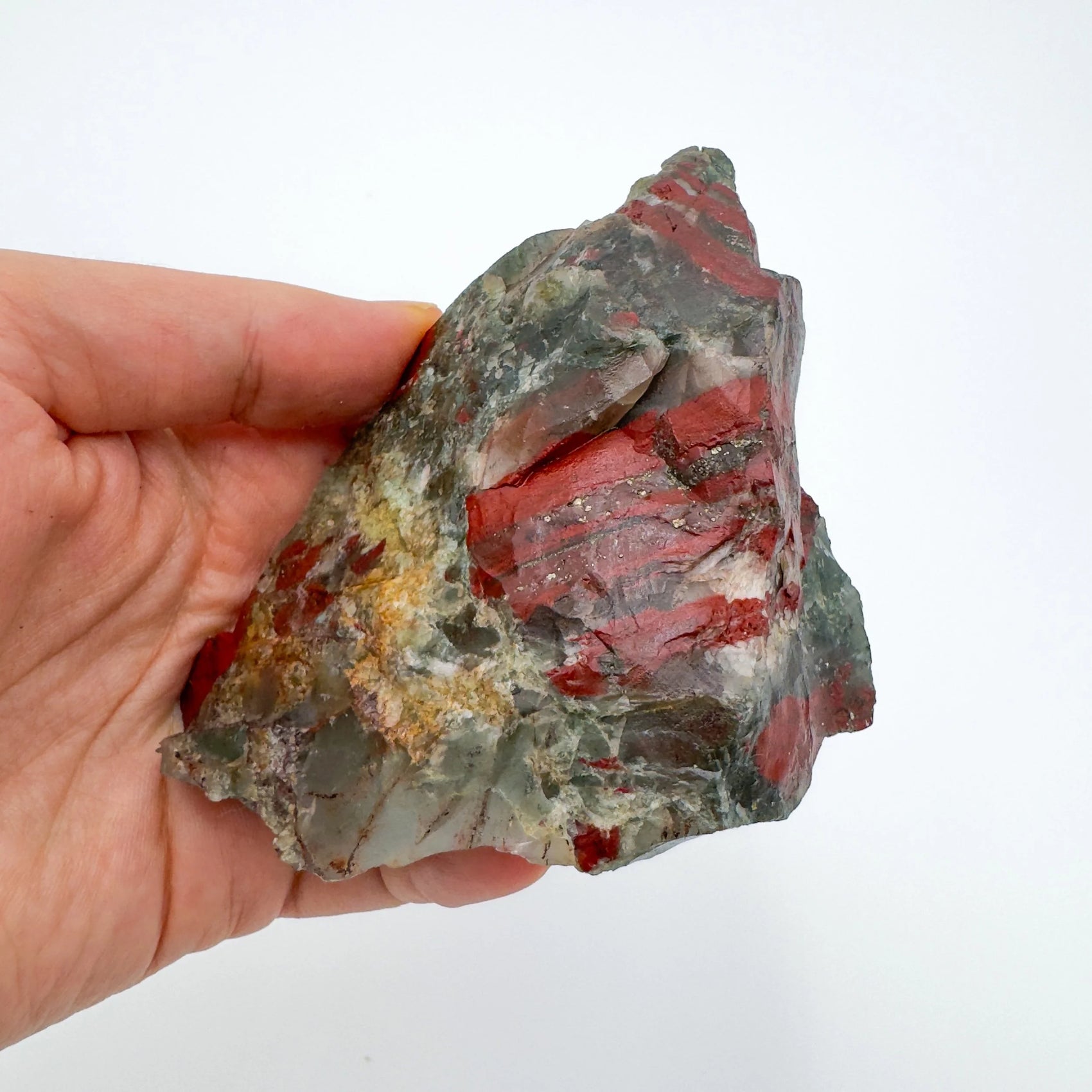 Companion image of Bloodstone specimen, from Hhohho, Eswatini, linked to Grounding, with subtle natural color showing through.