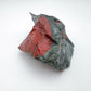 Overhead angle of green Bloodstone specimen, traditionally used for Energy, showing natural banding.