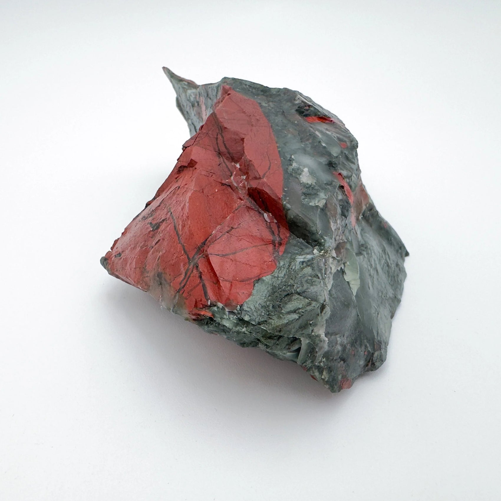Overhead angle of green Bloodstone specimen, traditionally used for Energy, showing natural banding.