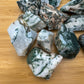 Up-close view of Grade A green Tree Agate raw stone, showing honest grain.