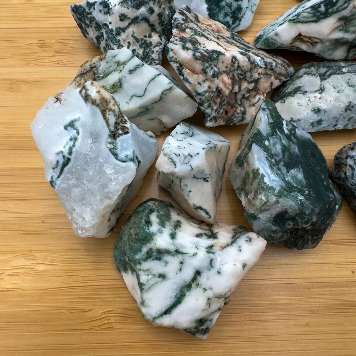 Up-close view of Grade A green Tree Agate raw stone, showing honest grain.