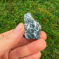 Full piece view of Tree Agate raw crystal, from Central District, Botswana, shown for proportion against the hand.