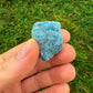 Side angle of blue Apatite raw stone, showing natural variation, sourced from Madagascar.