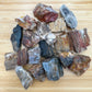 Texture-level view of Petrified Wood raw stone, showing natural form.