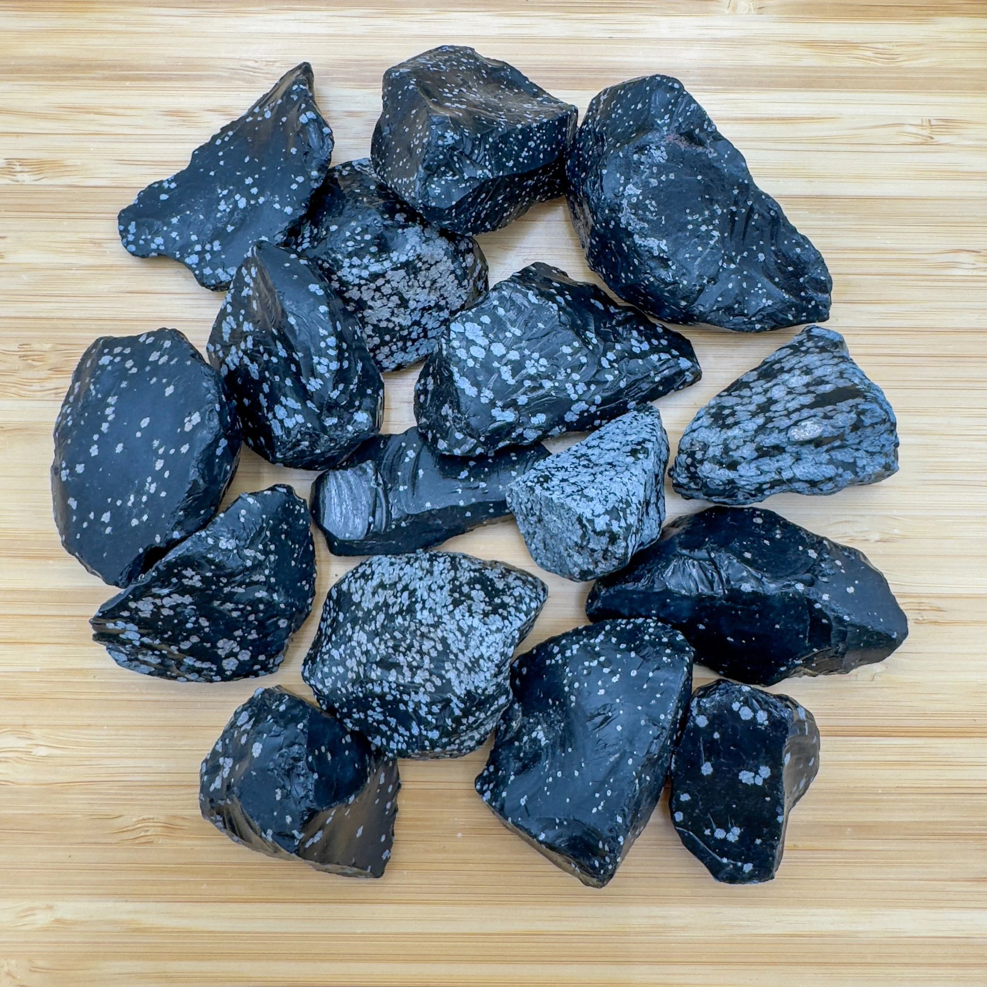 Color detail of Snowflake Obsidian raw stone, showing natural color depth, for Grounding and Emotional Healing.