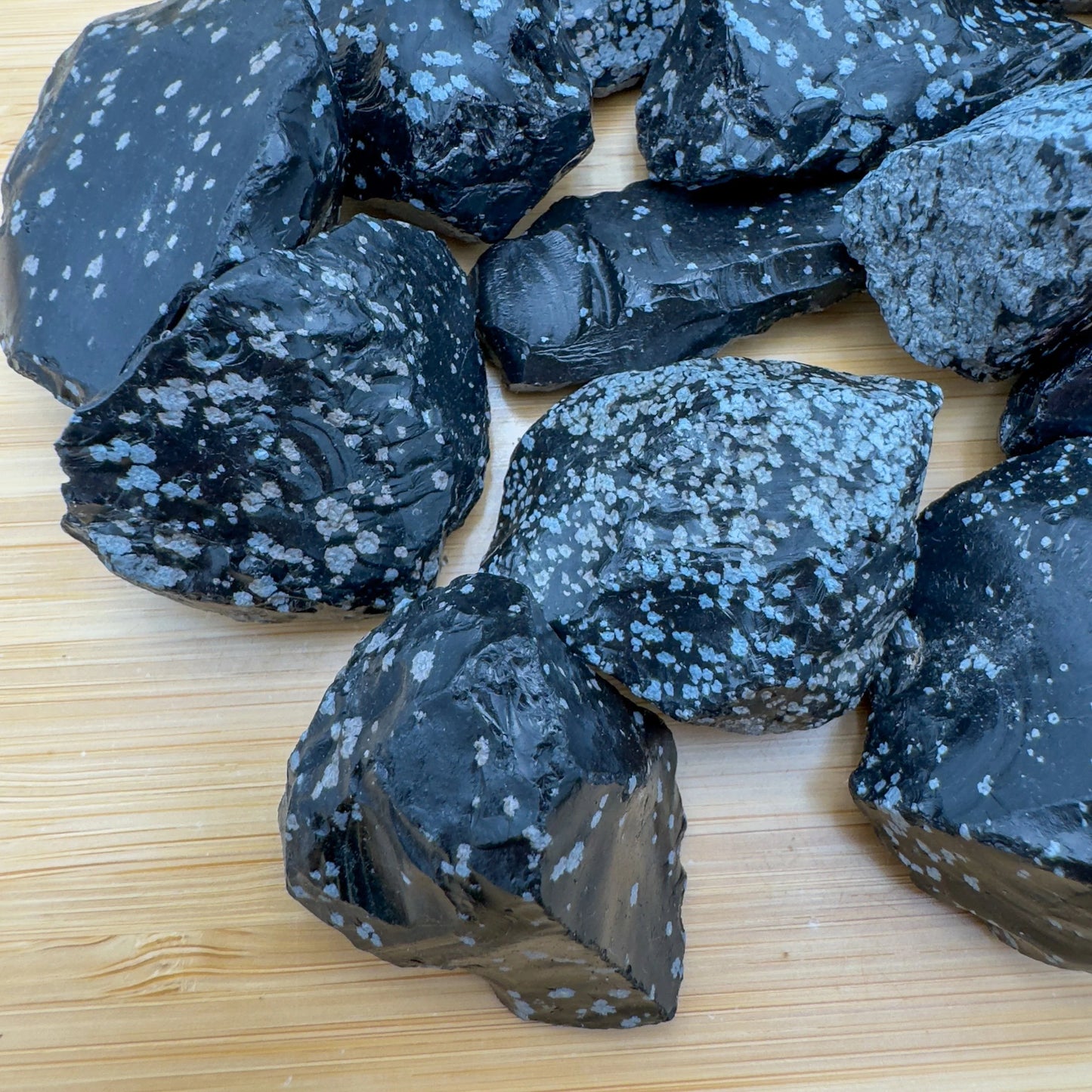 Plan view of black Snowflake Obsidian raw stone, from Utah, United States, kept near for Grounding.
