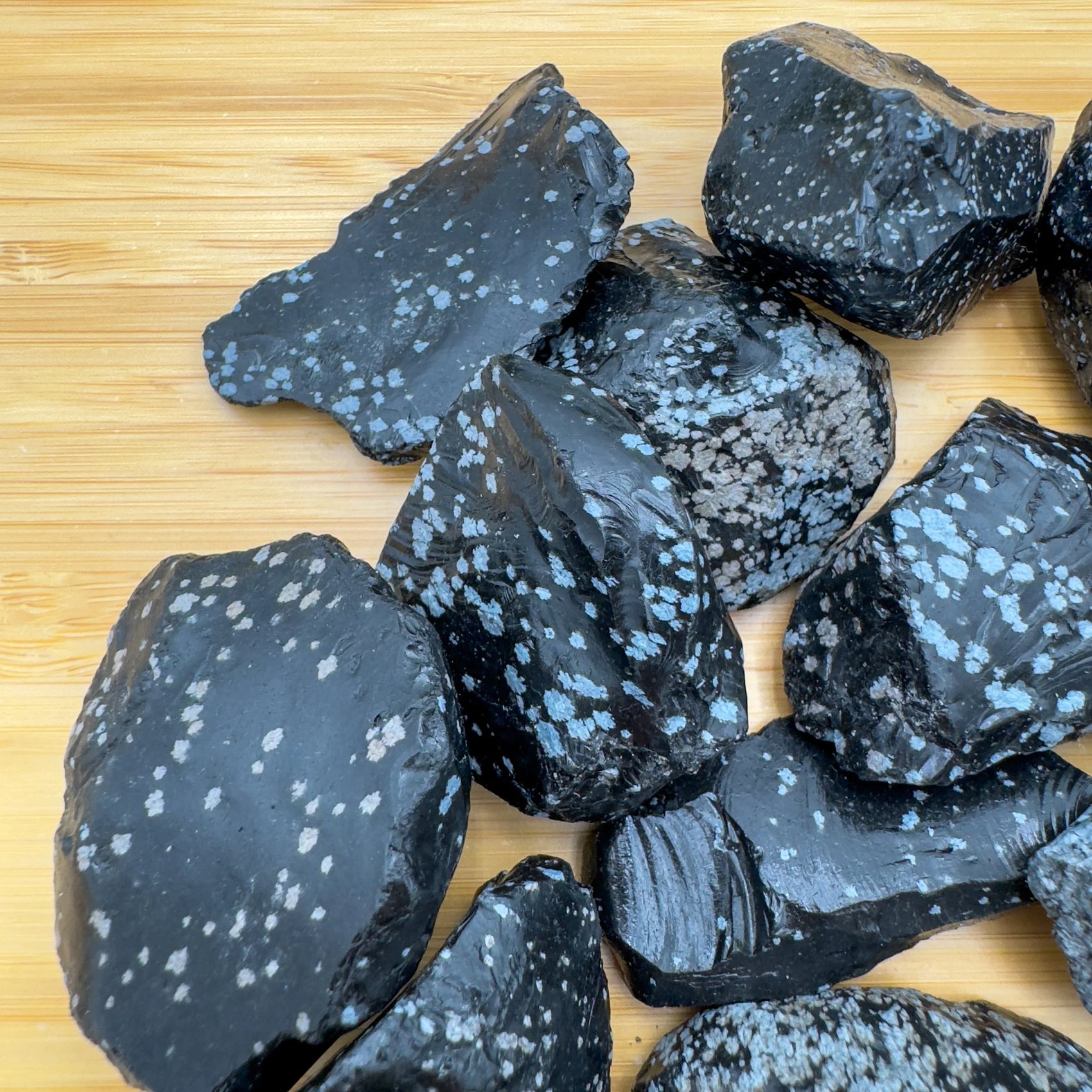 Close-up of Snowflake Obsidian raw stone, soothing wellness stone for Emotional Healing