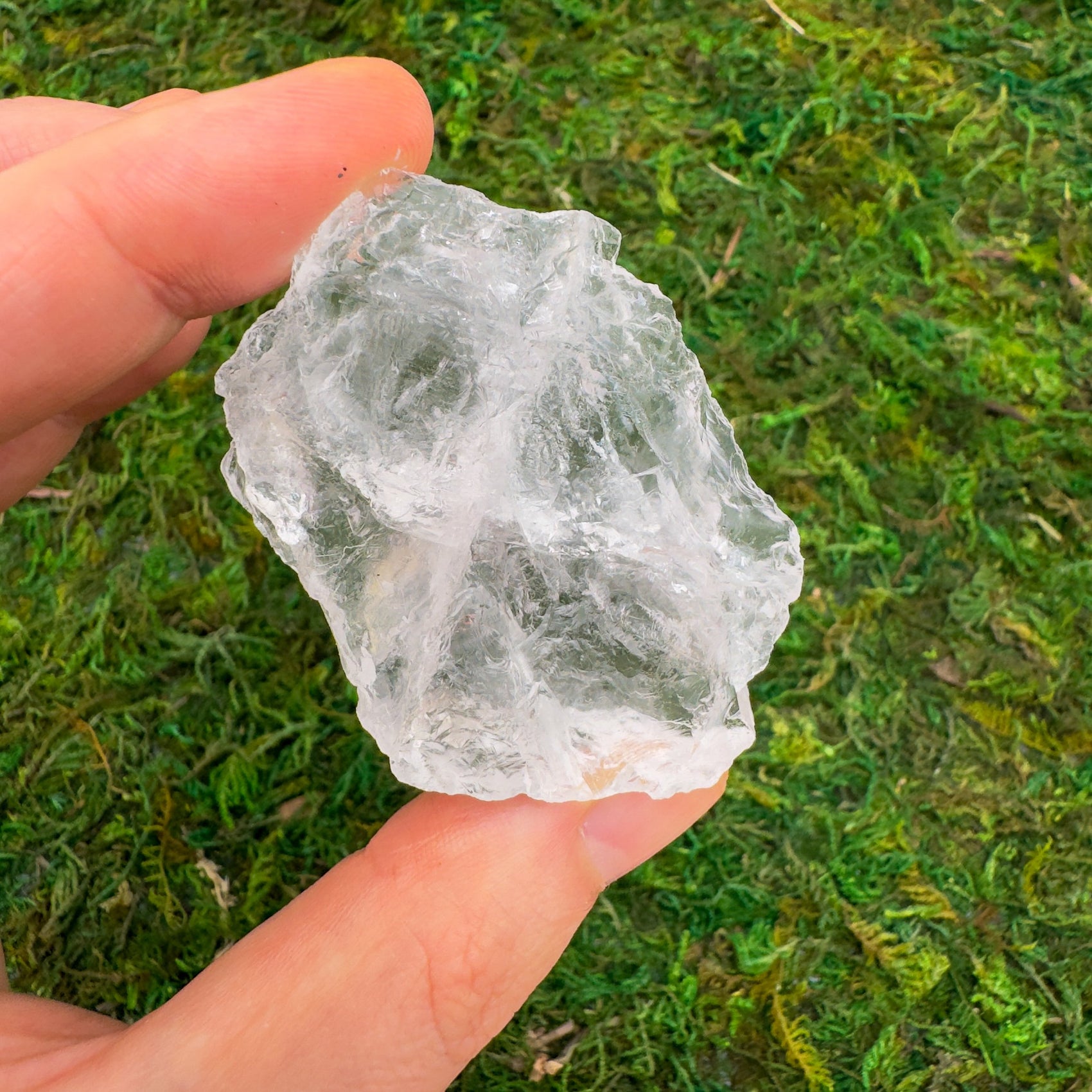 Back view of Grade AA Clear Quartz raw showing natural surface