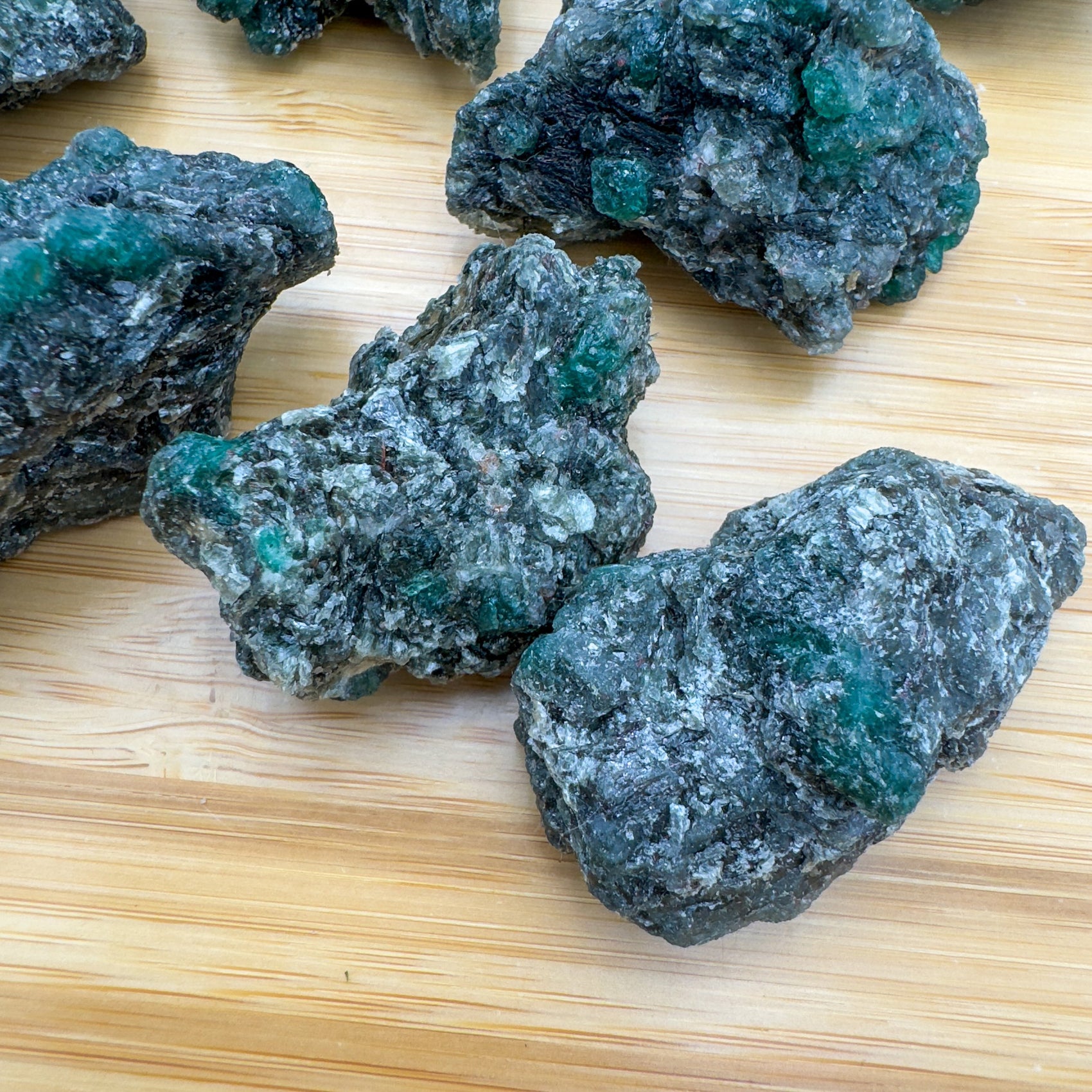 Lateral view of Grade AA Emerald raw stone, Zimbabwe-sourced.