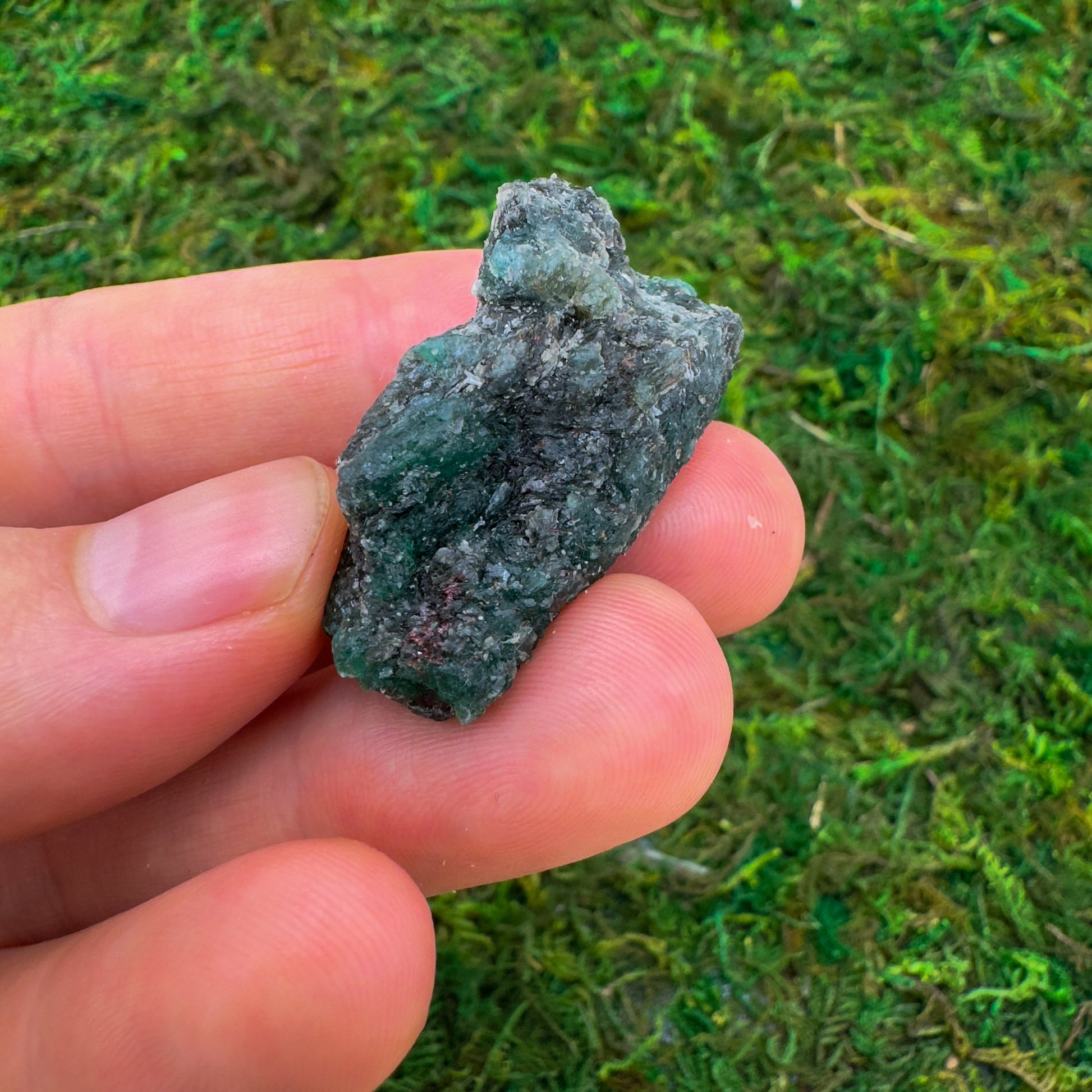 Styled with natural light Emerald raw crystal, from Midlands Province, Zimbabwe, often kept for Love, shown for proportion against the hand.
