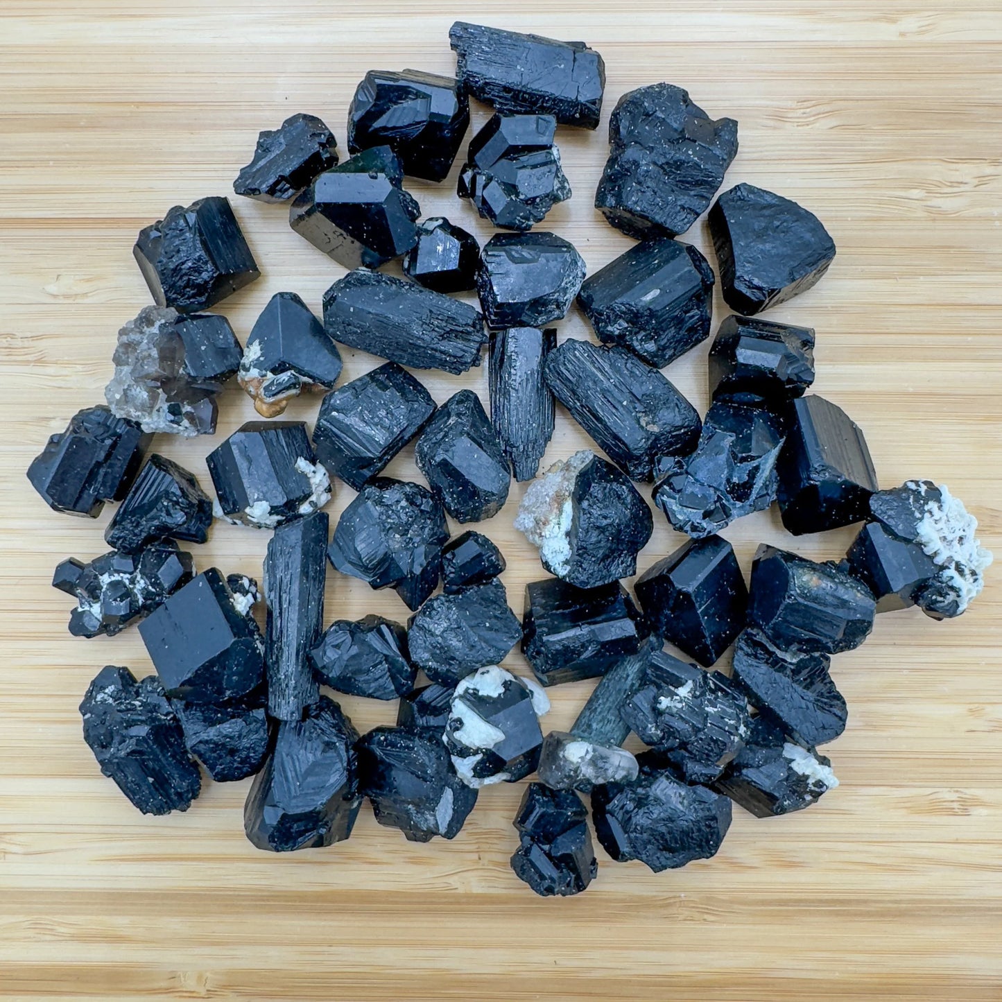 Sideways view of Black Tourmaline raw stone, Namibia-sourced, showing honest grain.
