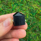 Alternate angle of Grade AA Black Tourmaline raw showing overall shape