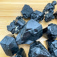 Looking down on Black Tourmaline raw stone, showing open form, linked to Protection and Grounding.