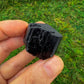 Detail shot of Grade AA Black Tourmaline raw under natural light