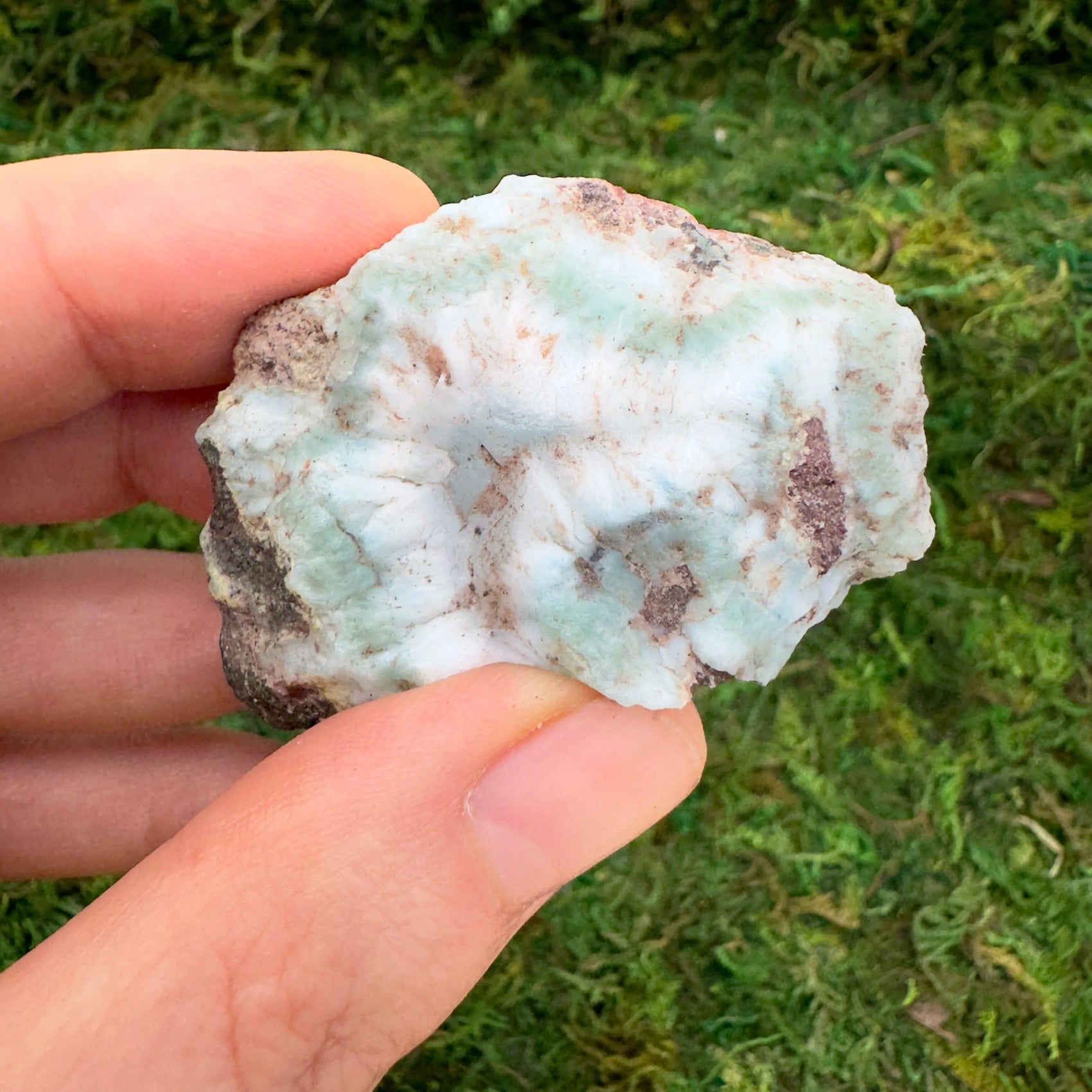 Top-down shot of blue Larimar raw stone, hand-selected from Barahona Province, Dominican Republic, worked with for Stress Relief.