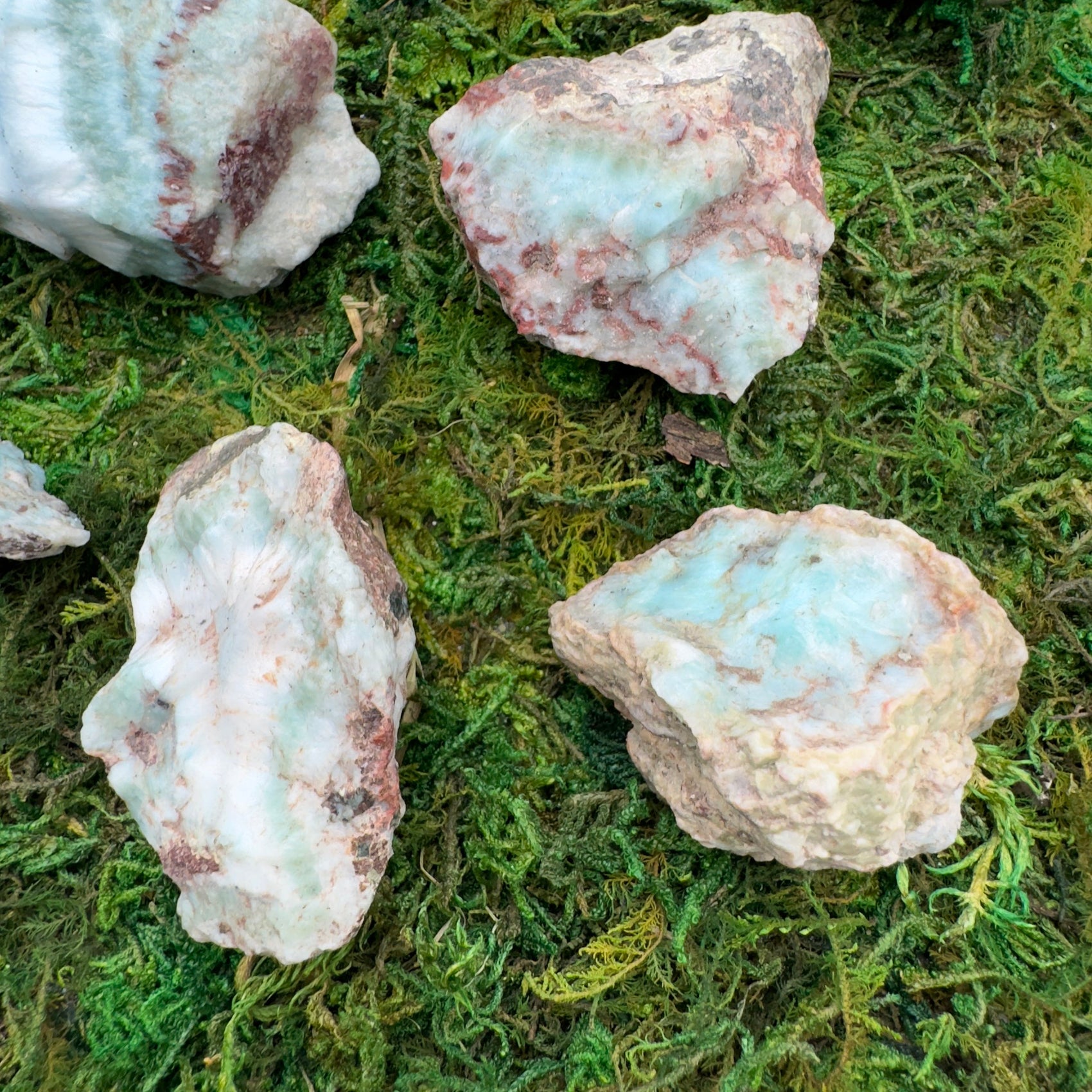 Grade a larimar raw held in hand for size reference