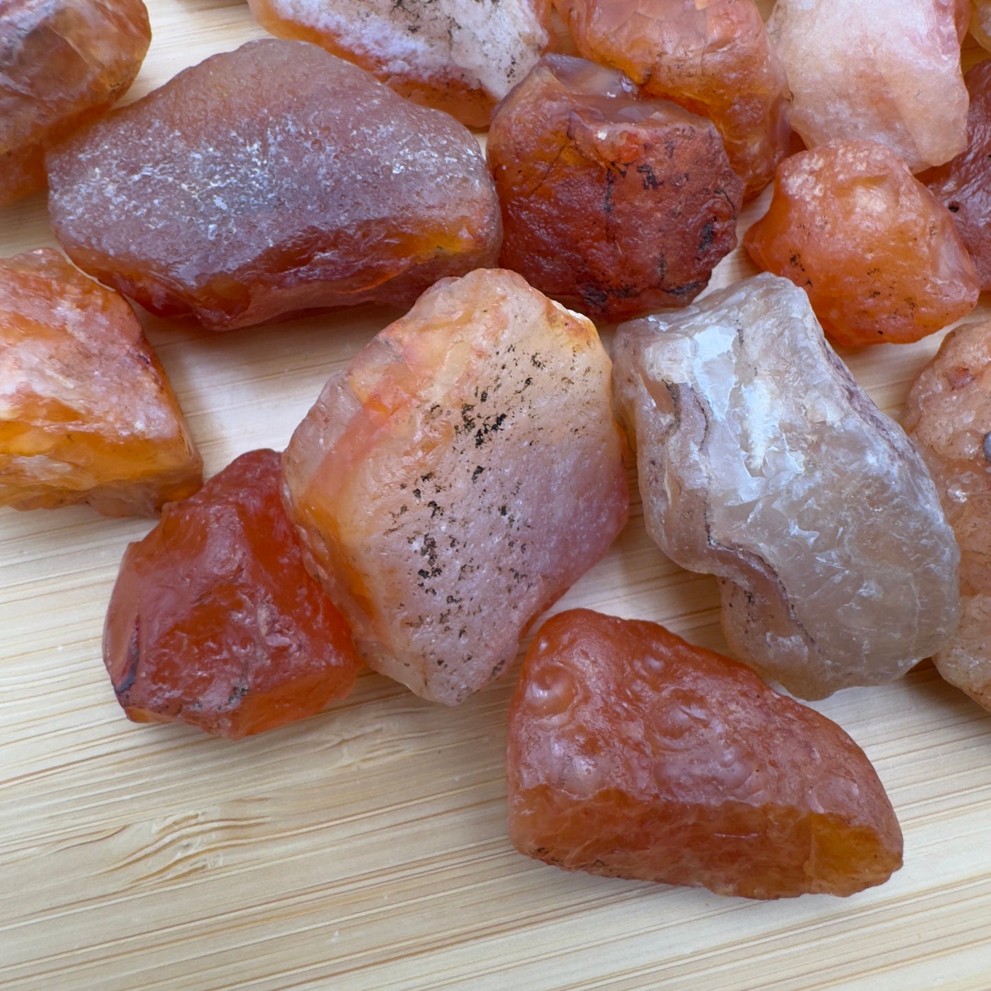 Close-up detail of Grade A Carnelian raw showing natural orange, red tones and texture