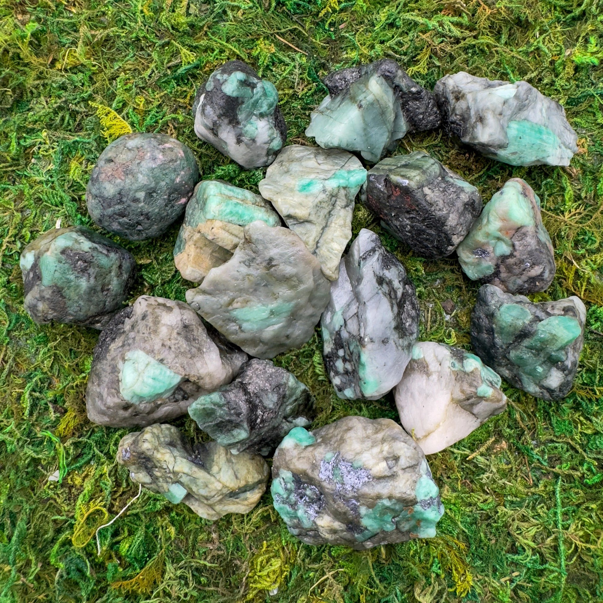 Natural light view of one Emerald raw stone for scale, sourced from Brazil.