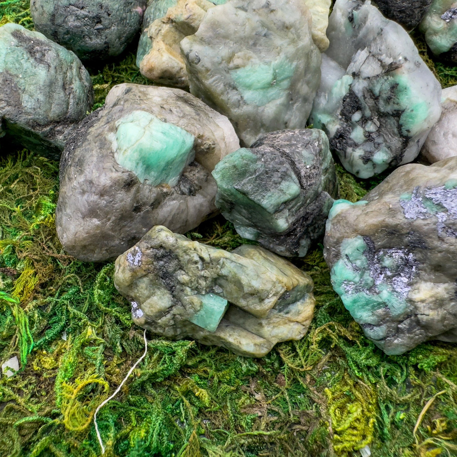 Worktop view of Emerald raw crystal, from Bahia, Brazil, often kept for Love, showing natural surface character.