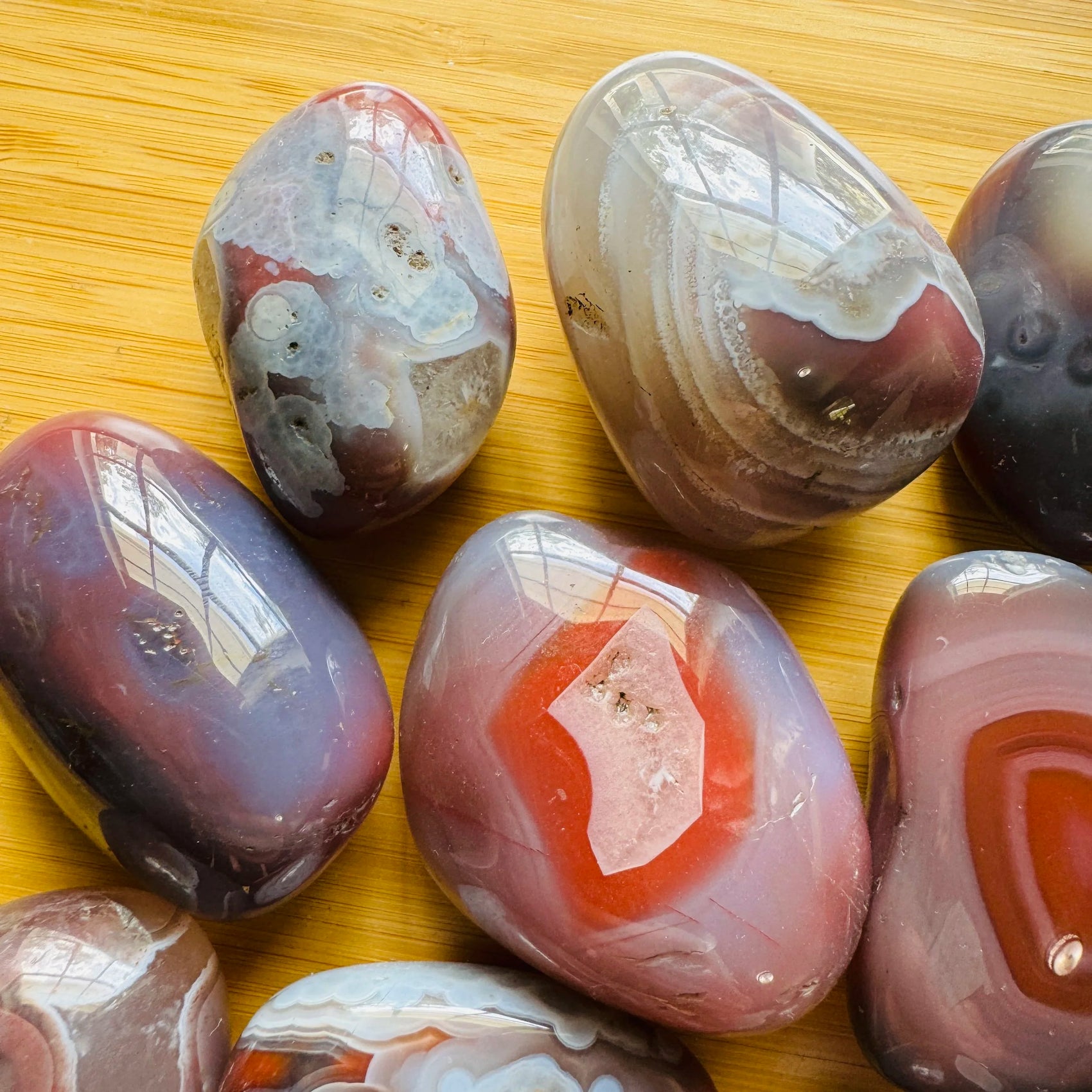 Profile view of Red Agate tumbled stone, sourced from Zimbabwe, linked to Grounding.
