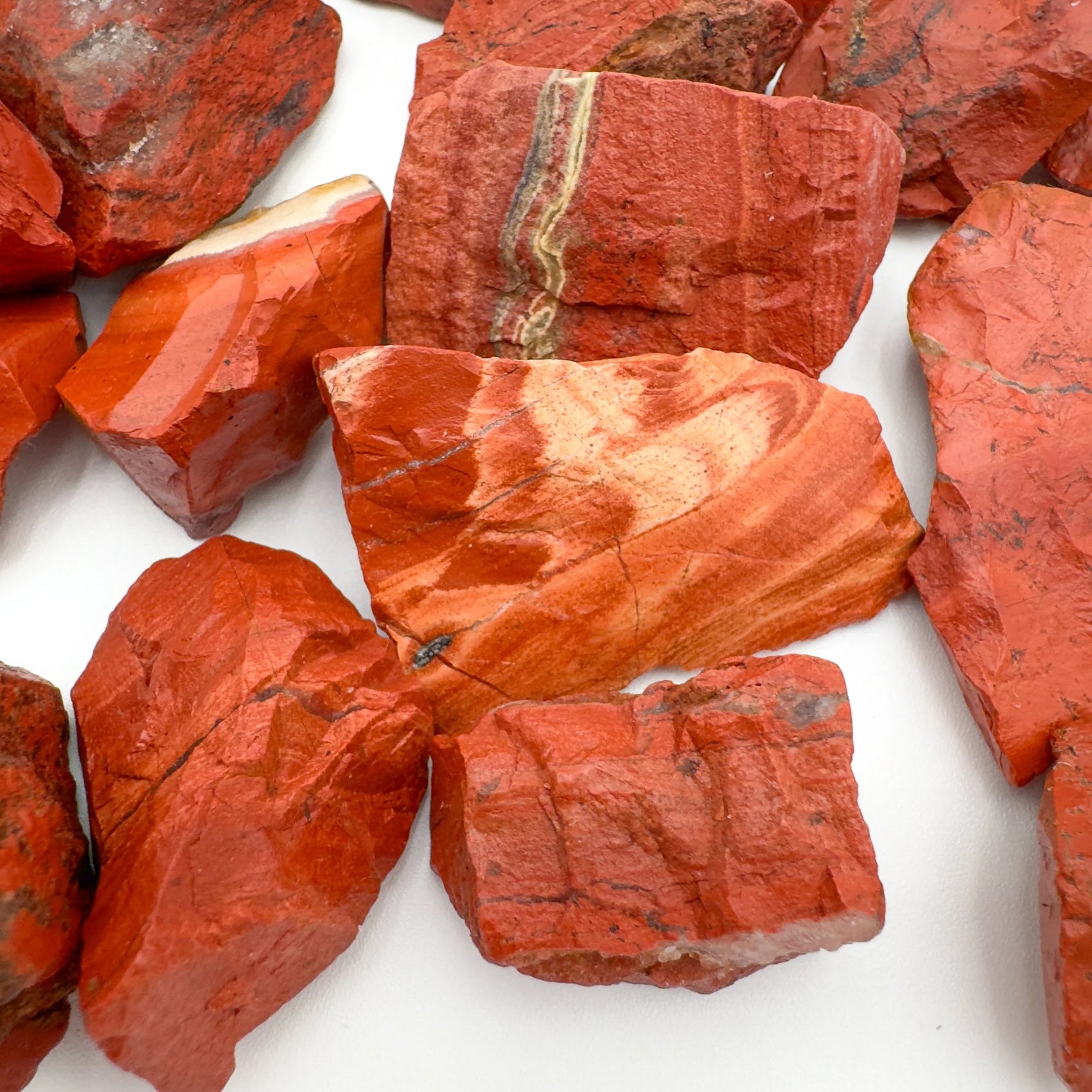 Profile view of Grade AA Red Jasper raw stone, showing natural variation.