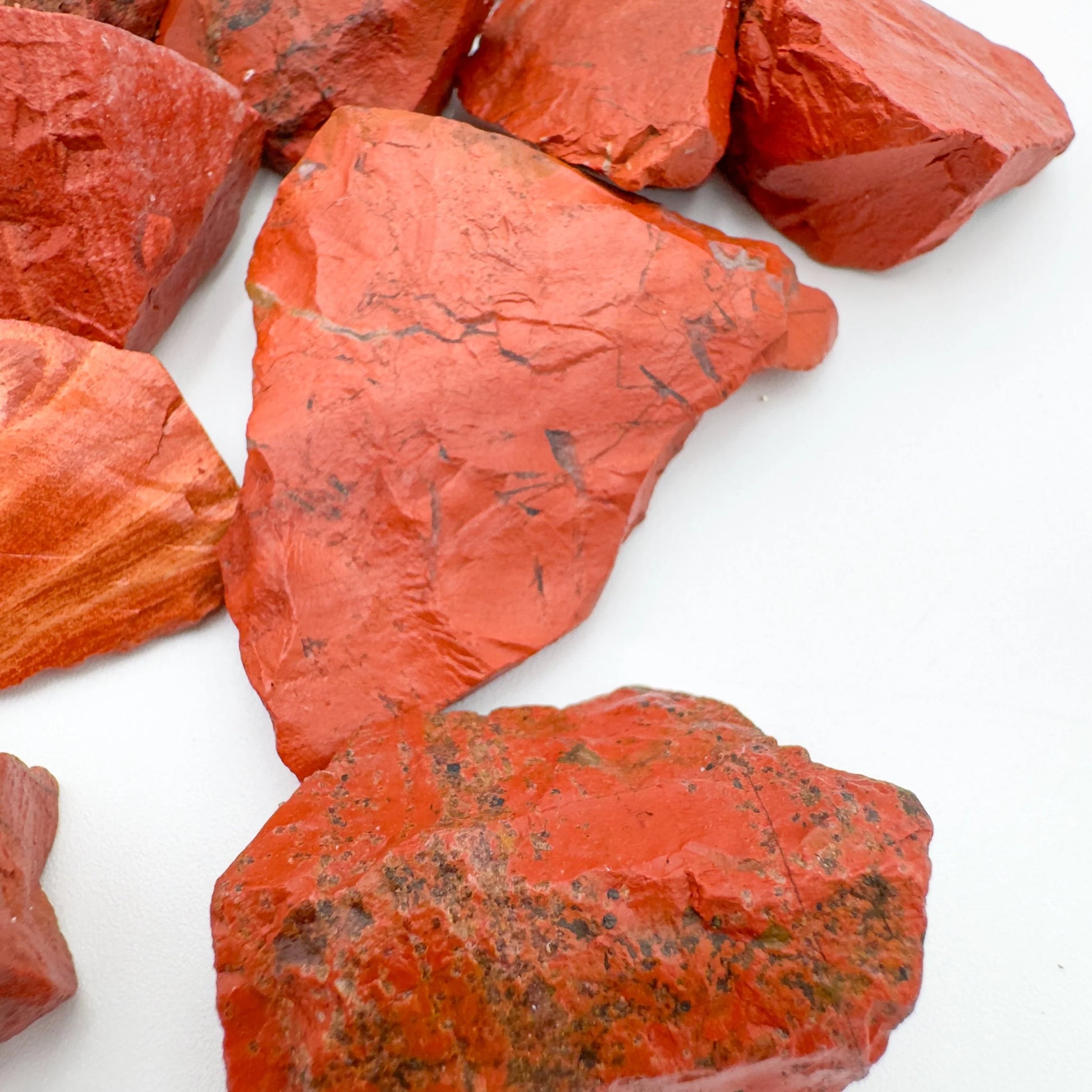 Open-palm view of Red Jasper raw crystal, linked to Grounding, shown for shape and scale.
