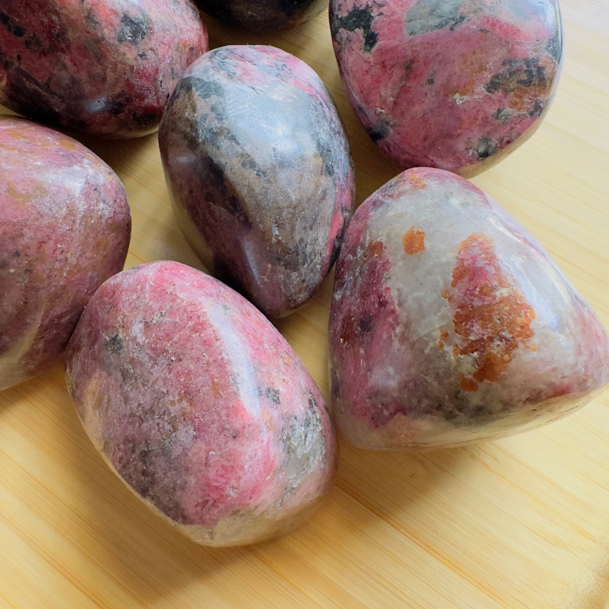 Profile view of Rhodonite freeform, often worked with for Emotional Healing, showing characteristic finish.