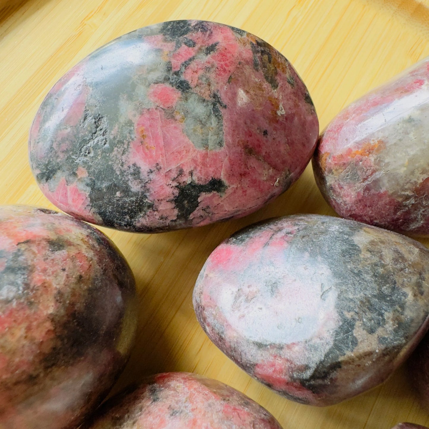 Near view of Rhodonite freeform, sourced from Zimbabwe, showing natural texture.