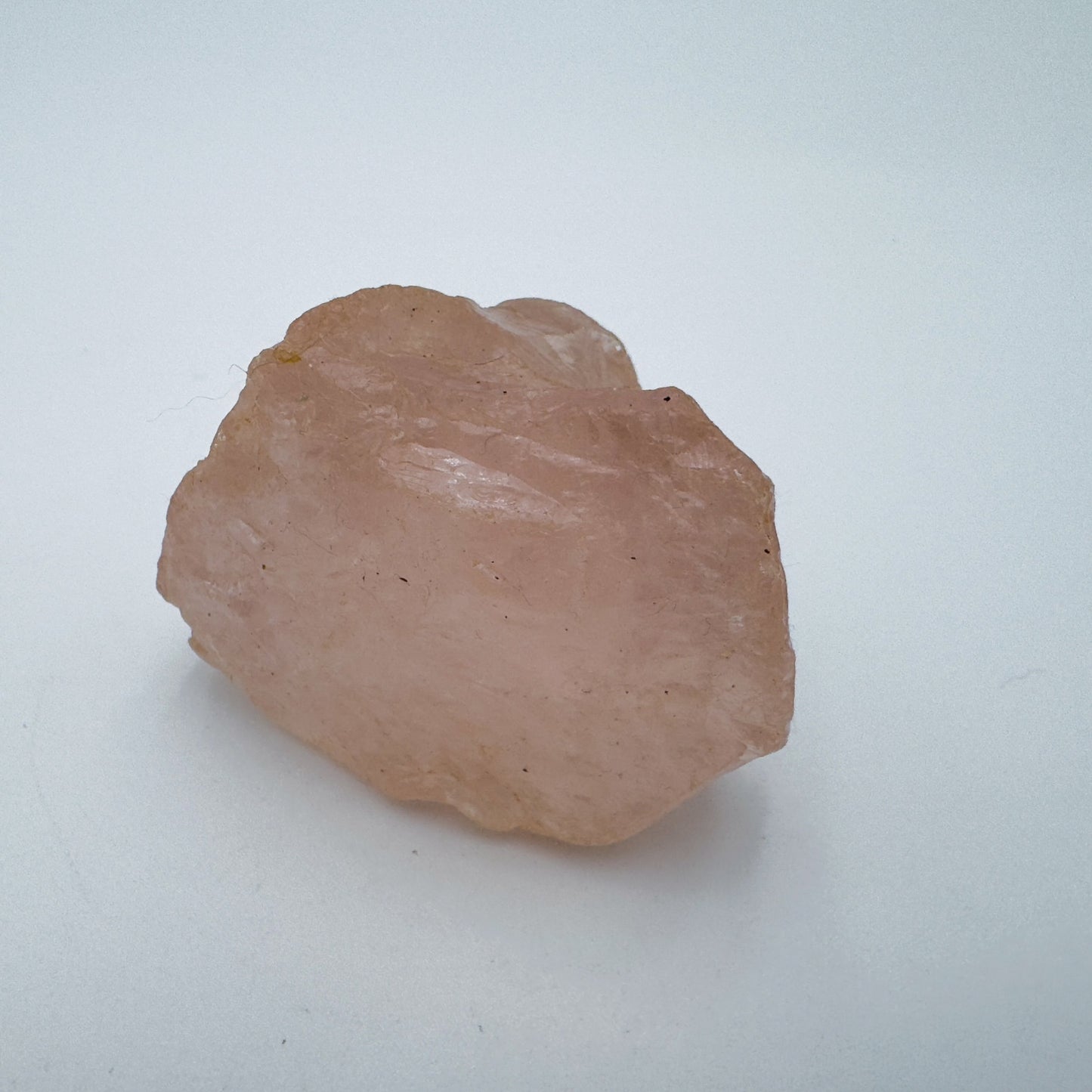 Edge view of Rose Quartz specimen, Madagascar-sourced, showing characteristic color.