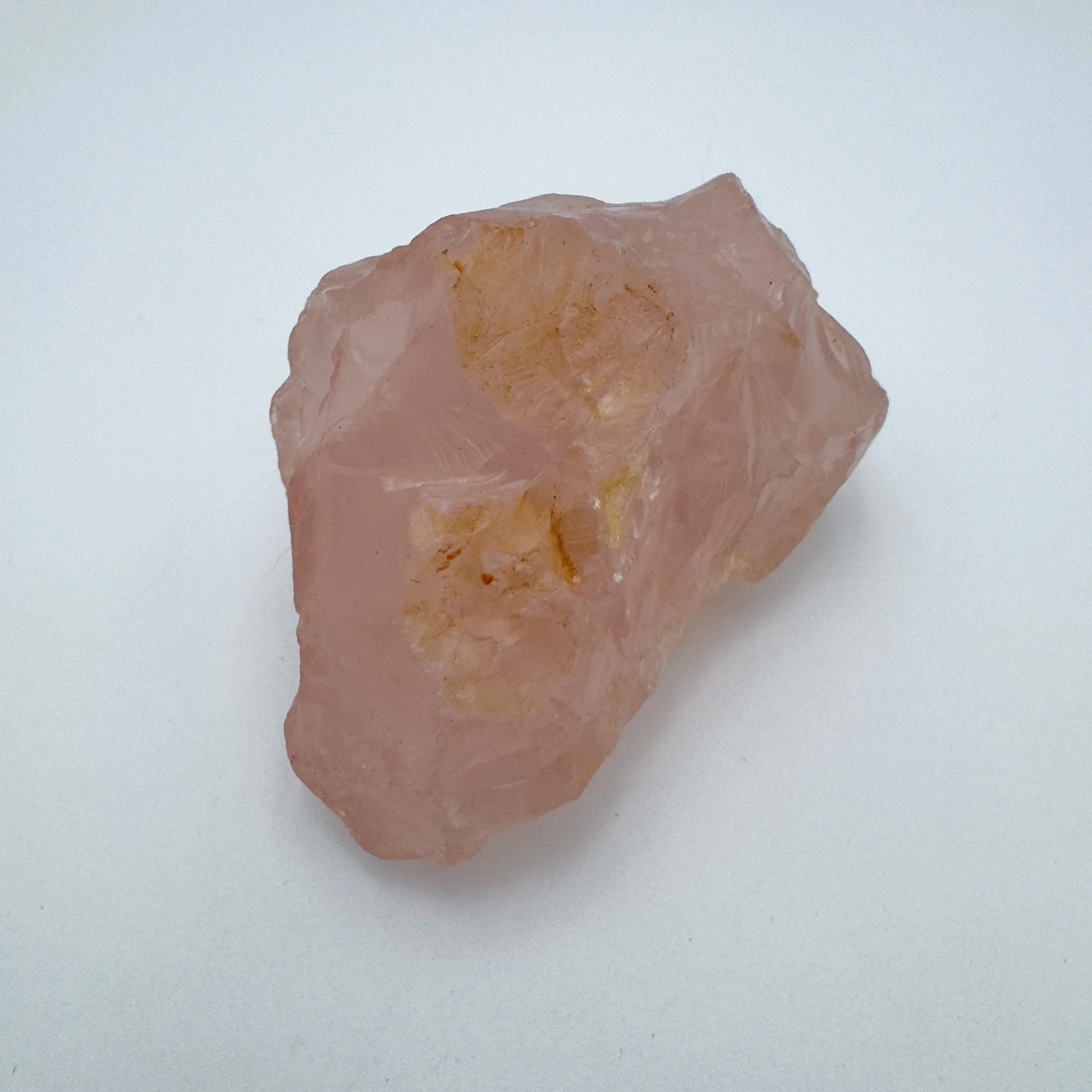 Side perspective of Rose Quartz specimen, sourced from Alaotra-Mangoro, Madagascar, showing earthy tone.