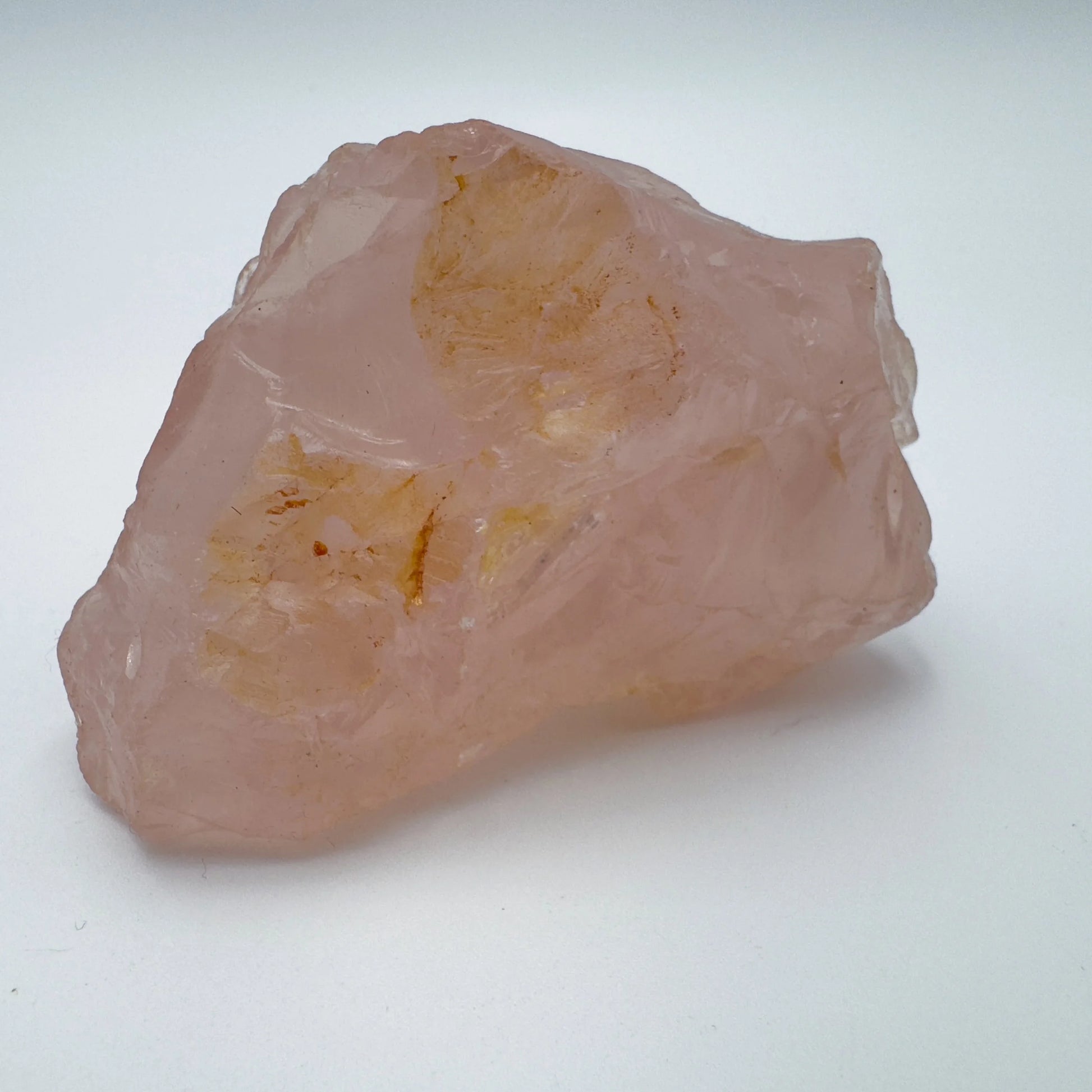 Considered view of Rose Quartz specimen, from Alaotra-Mangoro, Madagascar, set against a soft neutral surface.