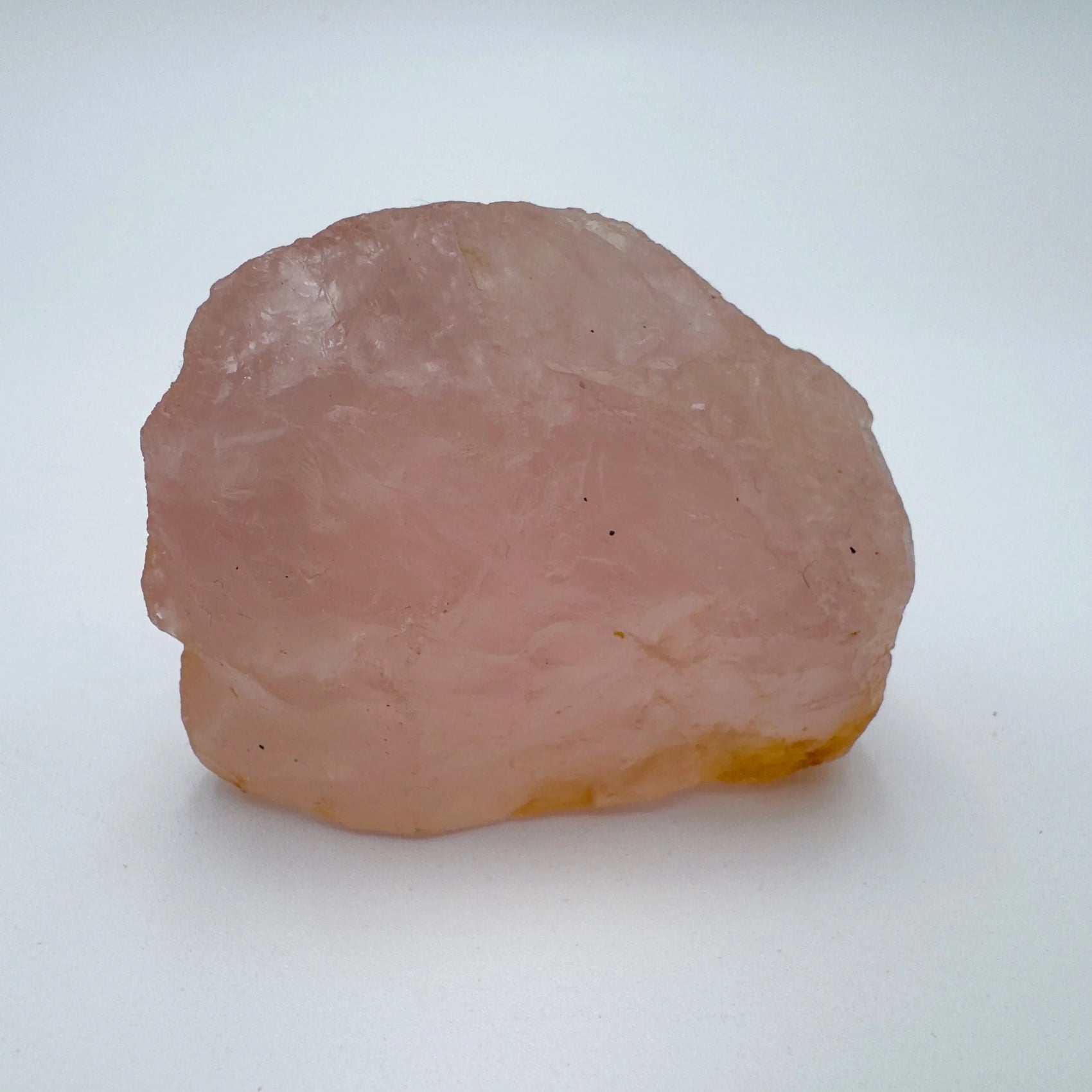 Side profile of Rose Quartz specimen, sourced from Alaotra-Mangoro, Madagascar, showing natural variation.