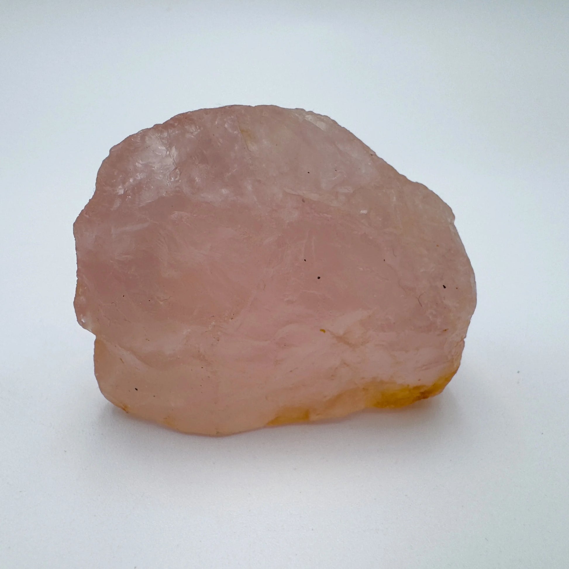 Side profile of Rose Quartz specimen, sourced from Alaotra-Mangoro, Madagascar, showing natural variation.
