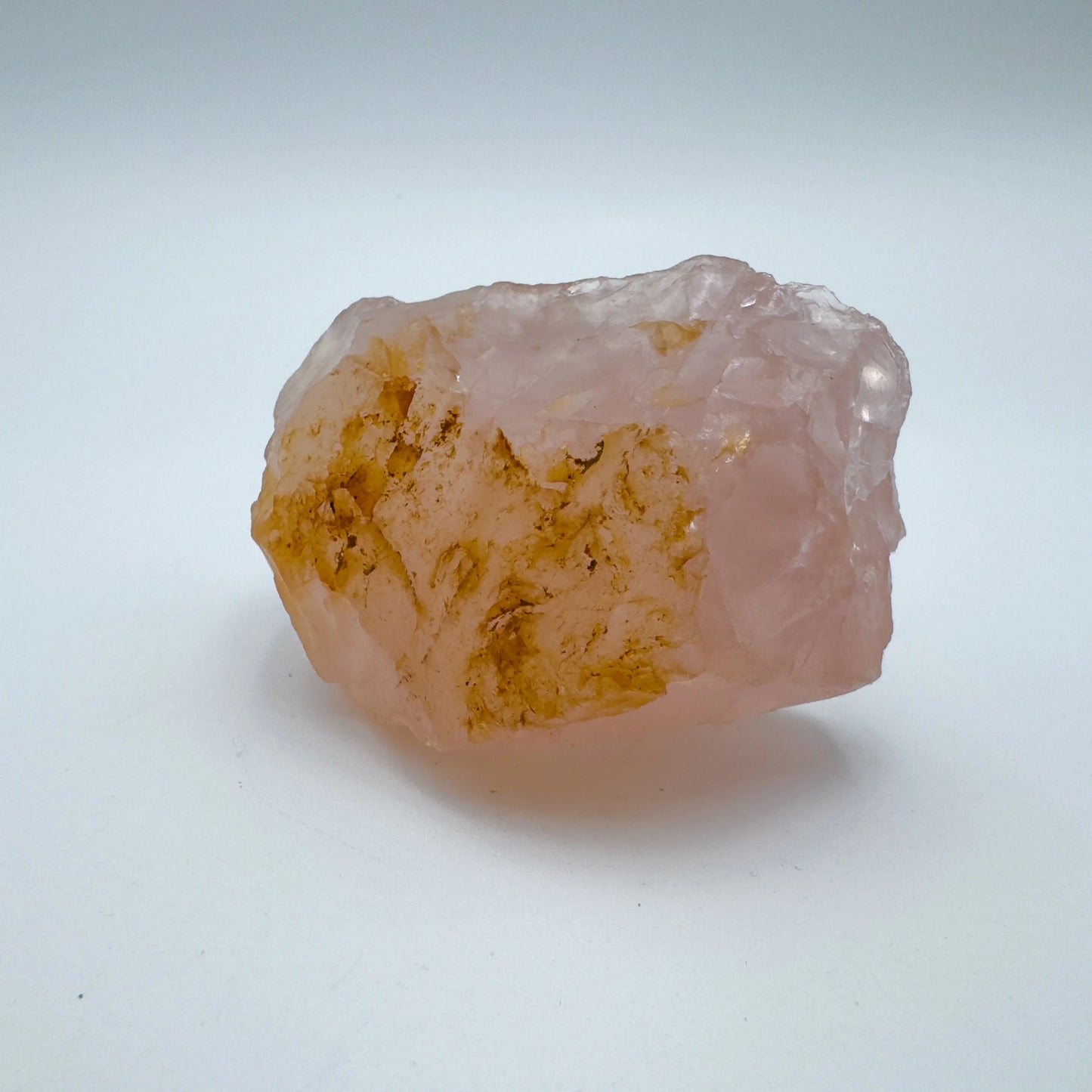 Edge view of Grade AAA Rose Quartz specimen, often worked with for Love and Self Love, showing raw matrix.