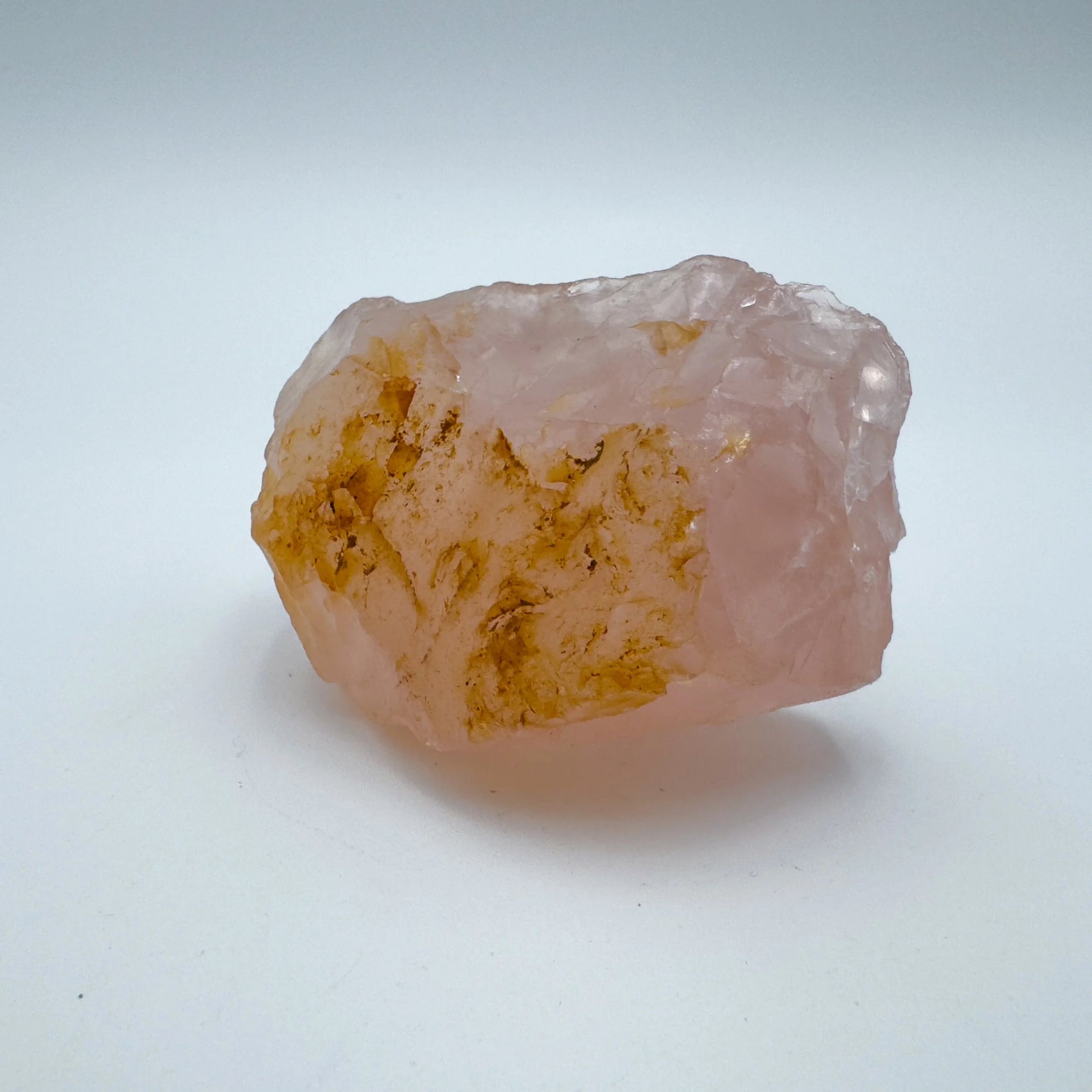 Edge view of Grade AAA Rose Quartz specimen, often worked with for Love and Self Love, showing raw matrix.