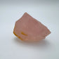 Profile shot of Rose Quartz specimen, traditionally used for Love, showing natural banding.