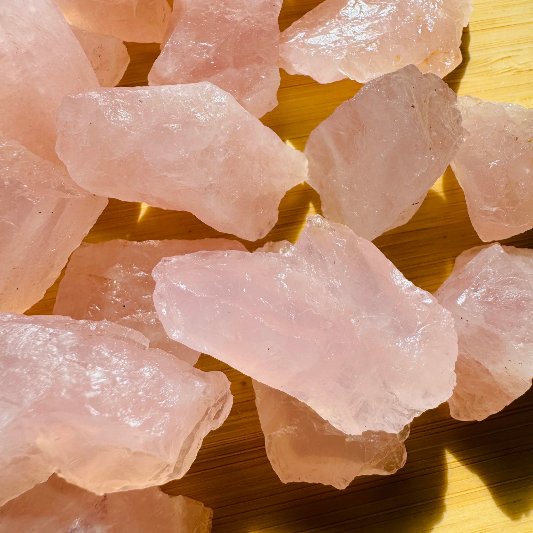 Side-on view of Grade AA Rose Quartz raw stone, associated with Love and Self Love.