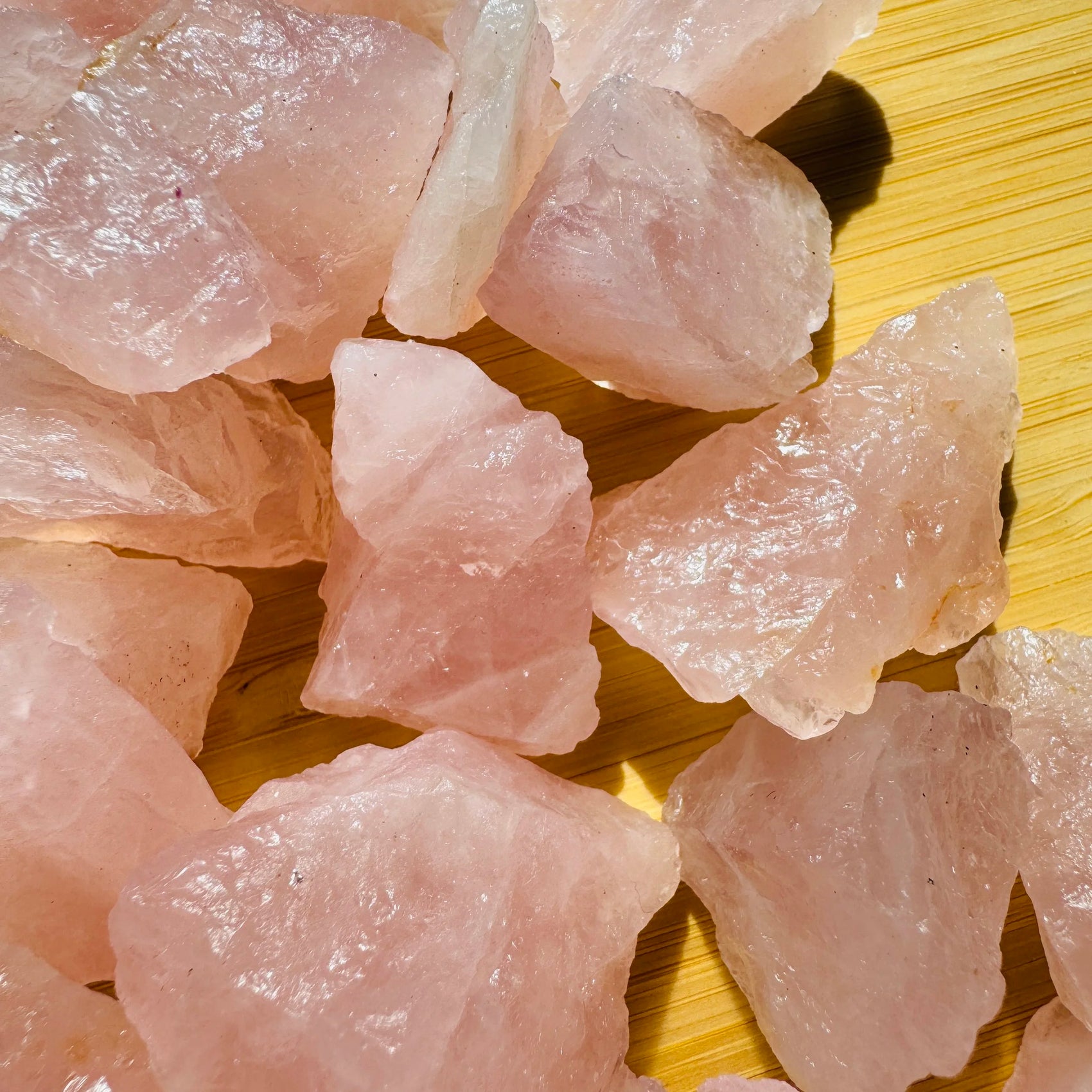 Texture-level view of pink Rose Quartz raw stone, showing natural inclusions, to support Love.