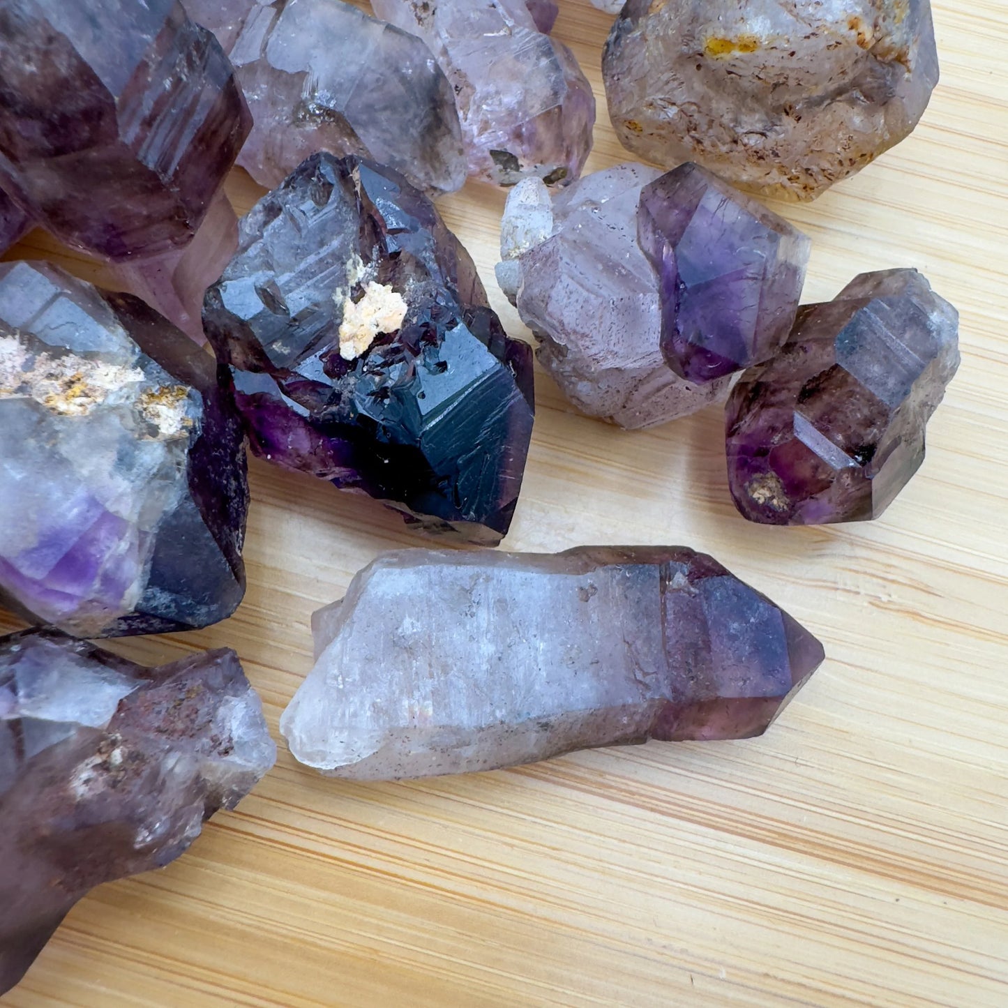 Tight crop of Smoky Amethyst raw point, sourced from Masvingo, Zimbabwe, showing subtle veining.
