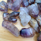 Side profile of Smoky Amethyst raw point, from Zimbabwe, showing subtle veining.