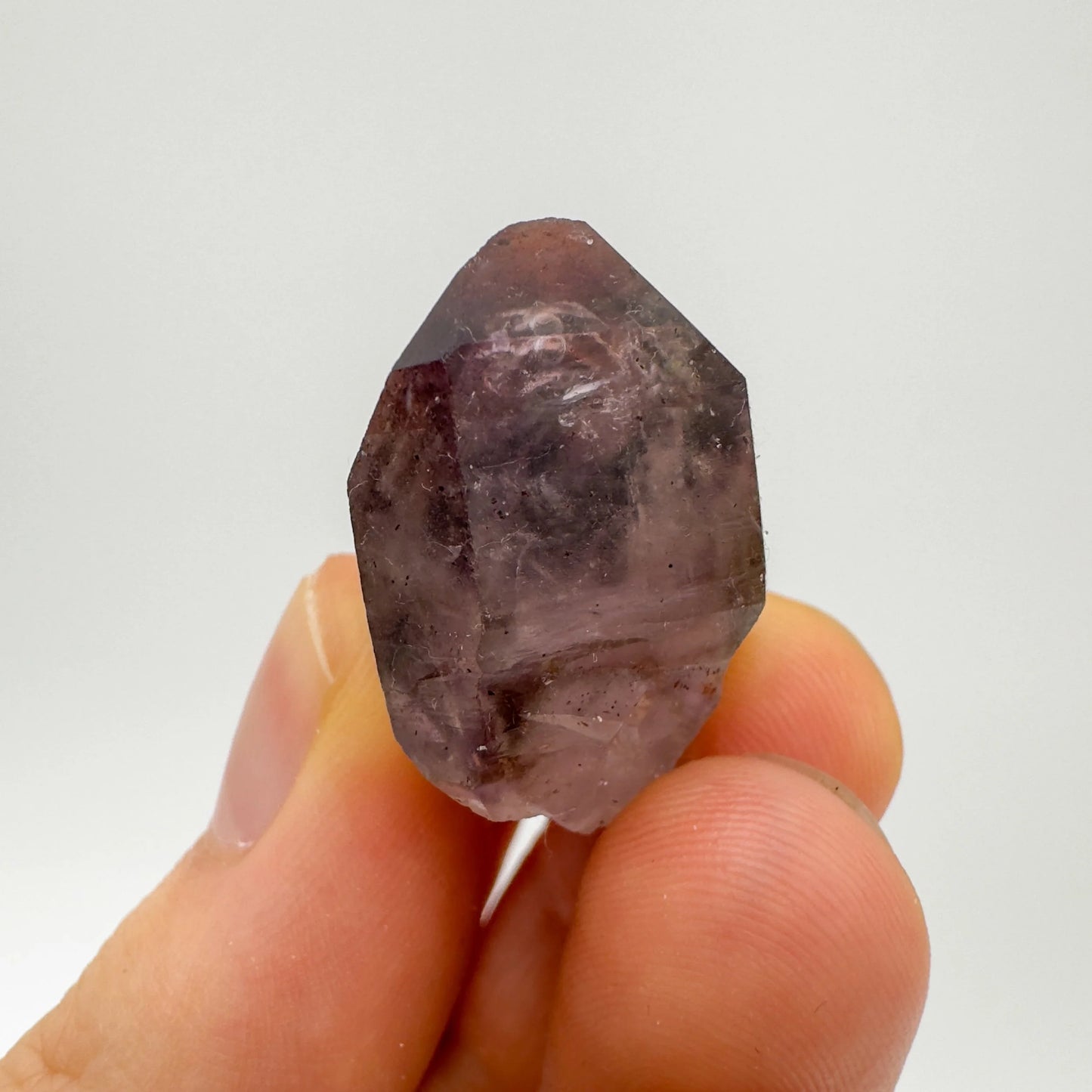 Detail shot of Grade A Smoky Amethyst point under natural light
